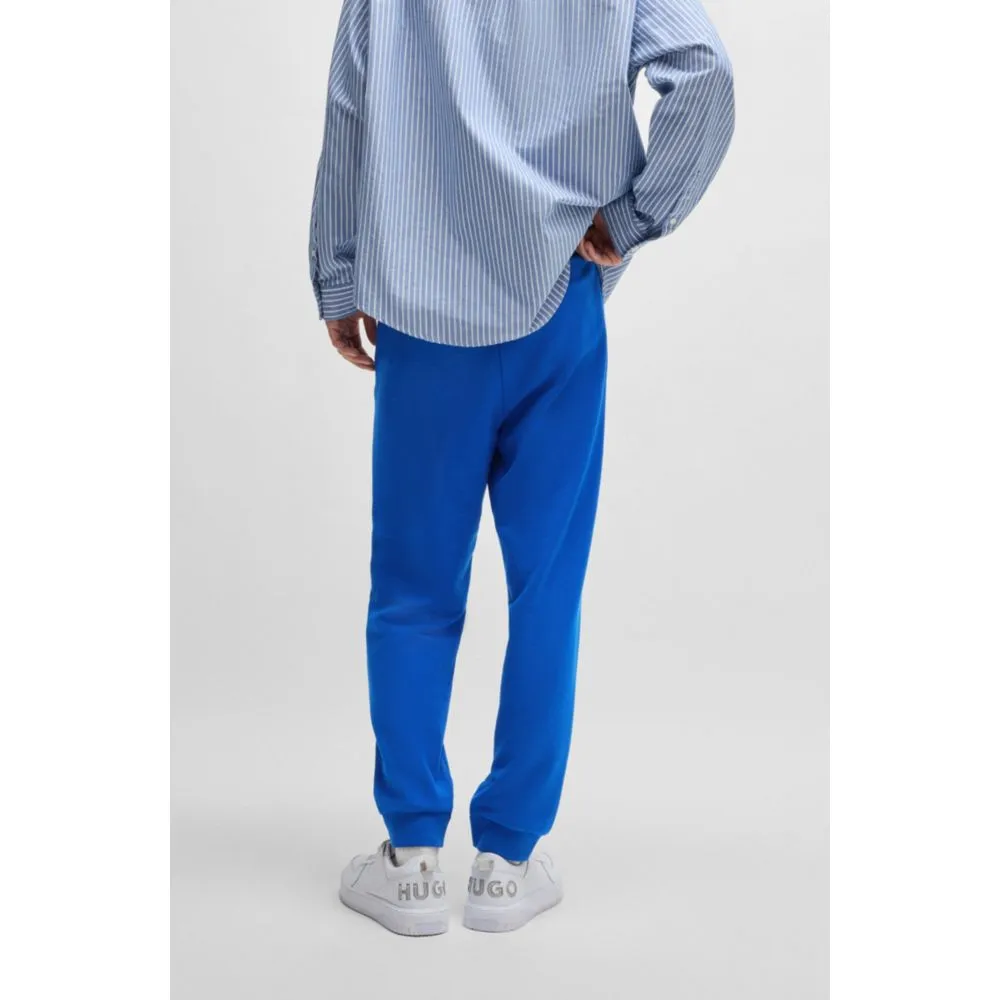 Cotton-terry tracksuit bottoms with Happy HUGO logo patch