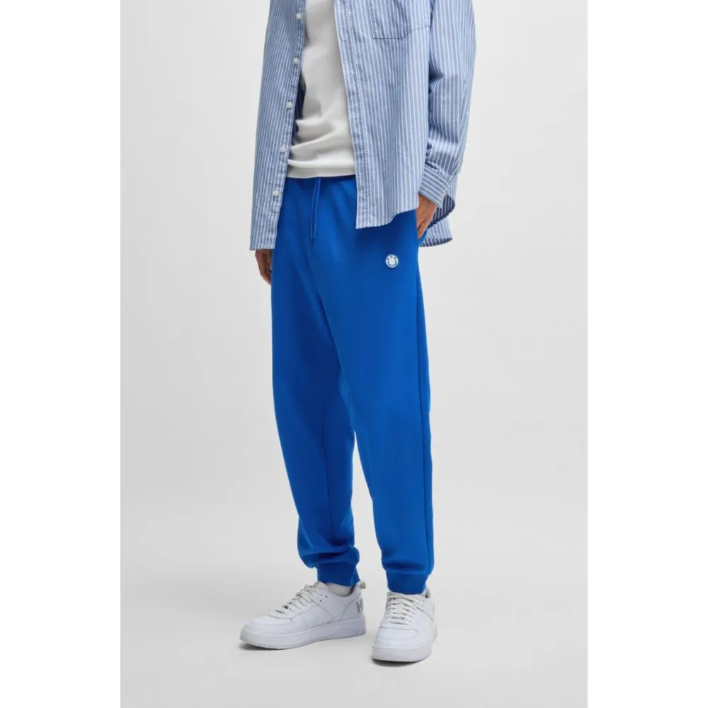 Cotton-terry tracksuit bottoms with Happy HUGO logo patch