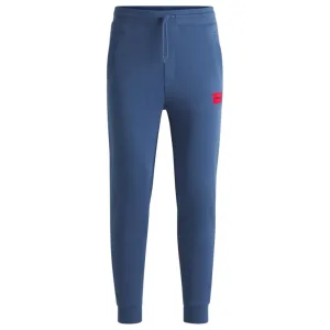 Cotton-terry tracksuit bottoms with red logo label