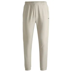Tracksuit bottoms in stretch fabric with decorative reflective logo